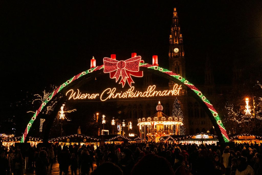 Festive atmosphere at Vienna's Christkindlmarkt with lights in winter.
